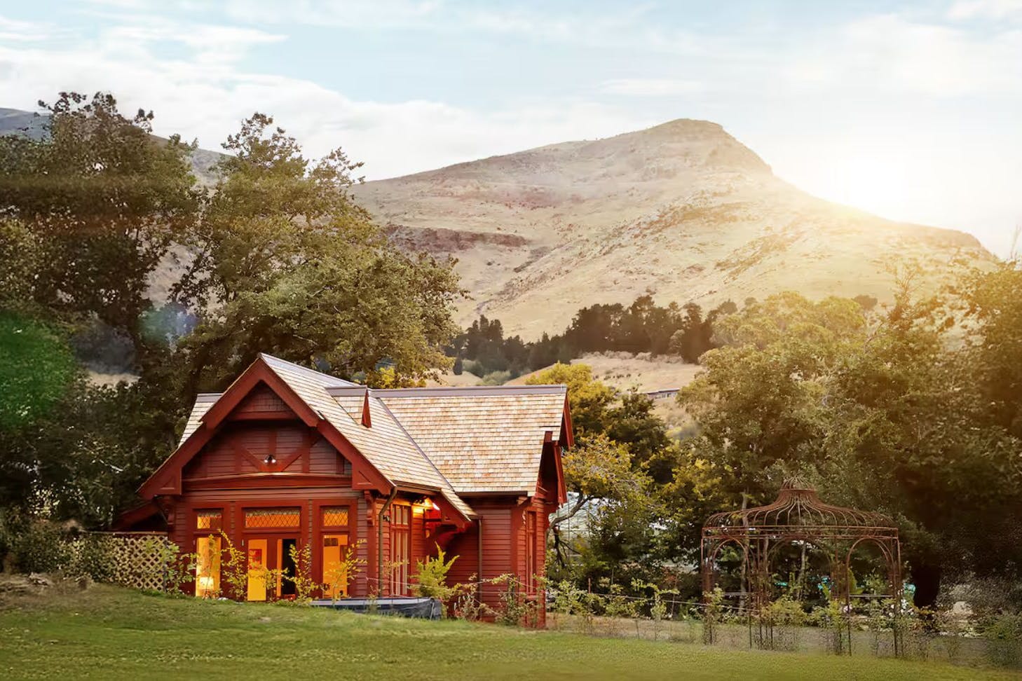 An exterior view of Casterton Cottage romantic Airbnb surrounded by garden in Christchurch, New Zealand